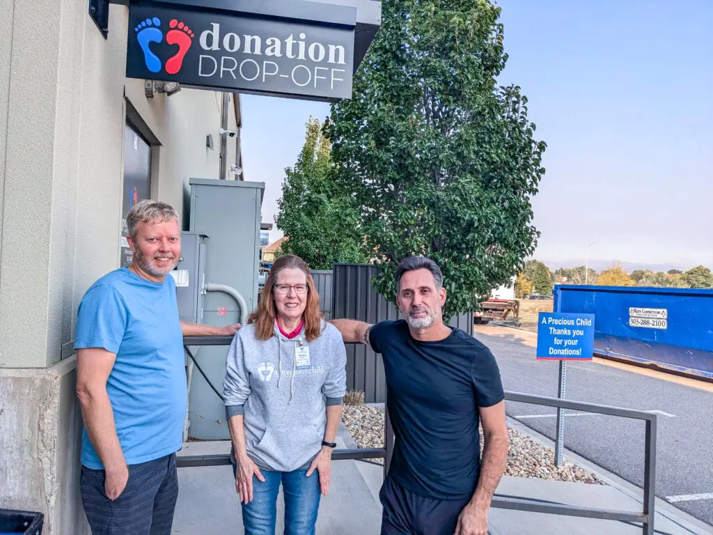 A Precious Child employees and volunteers smiling at the Drop-off location.