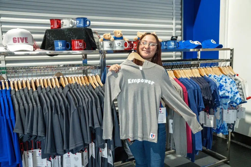 A Pathways participant smiling at her retail job.
