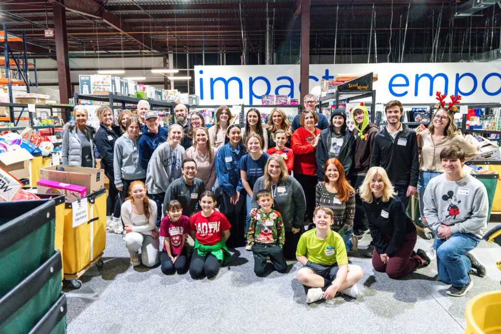 The Board with their families smiling in the Donation Center.