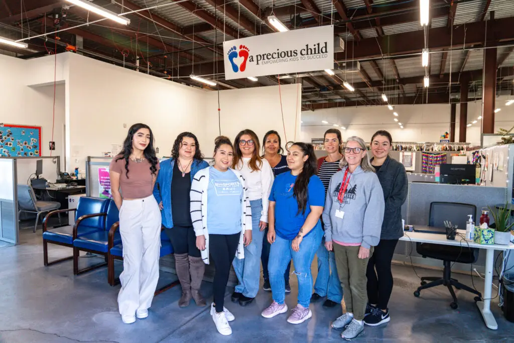 A Precious Child team smiling and posing in the main office.